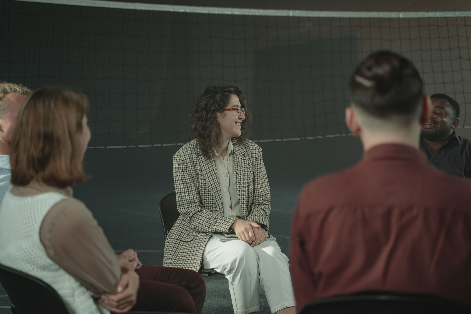 A diverse group of adults taking part in a focused conversation