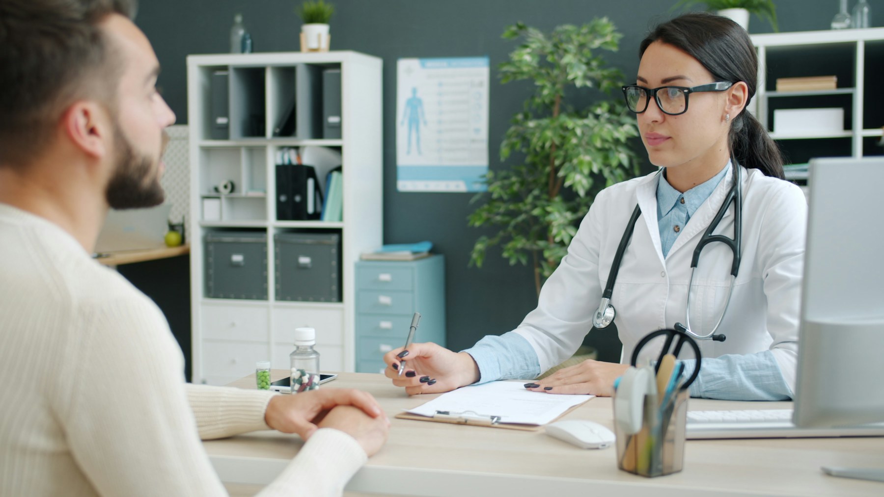 Healthcare professional speaking with a patient during an appointment