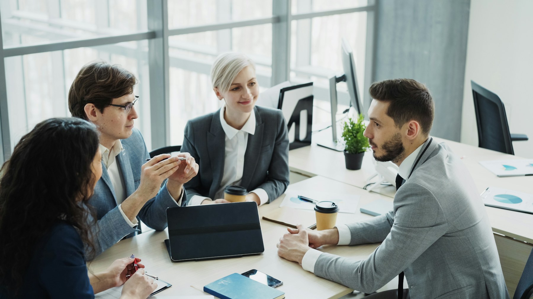 Professionals discussing a project around a conference table