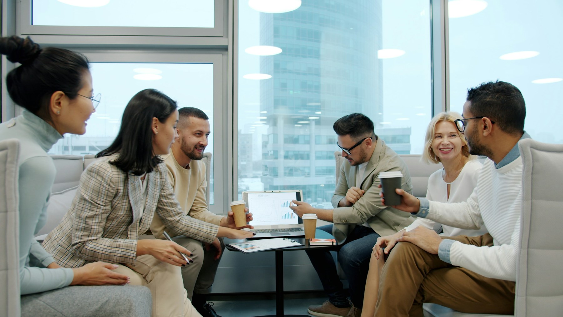A diverse organizational team meeting around a project