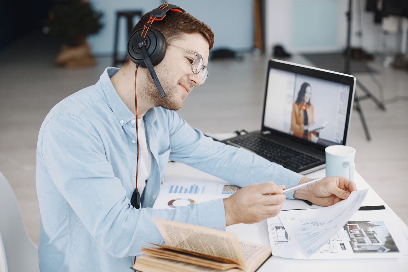 A professional reviewing documents during a remote call